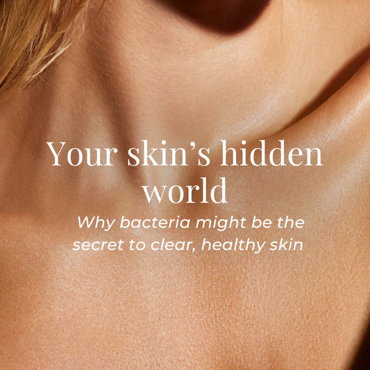 A zoomed-in, softly lit image of a person’s neck and upper chest with radiant, smooth skin. 