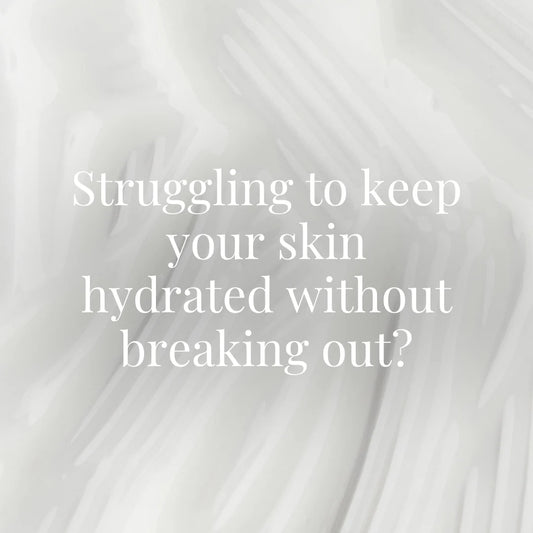 Abstract close-up background of a light, creamy skincare texture in soft white tones.